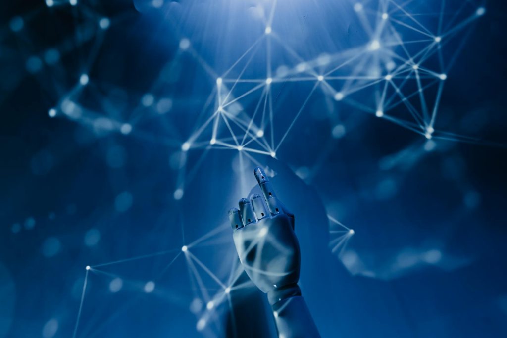 A robotic hand reaches up toward a stylized node cluster